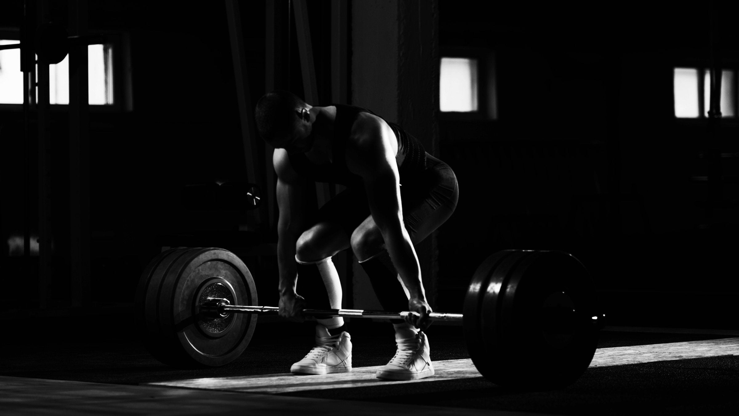 person powerlifting in gym